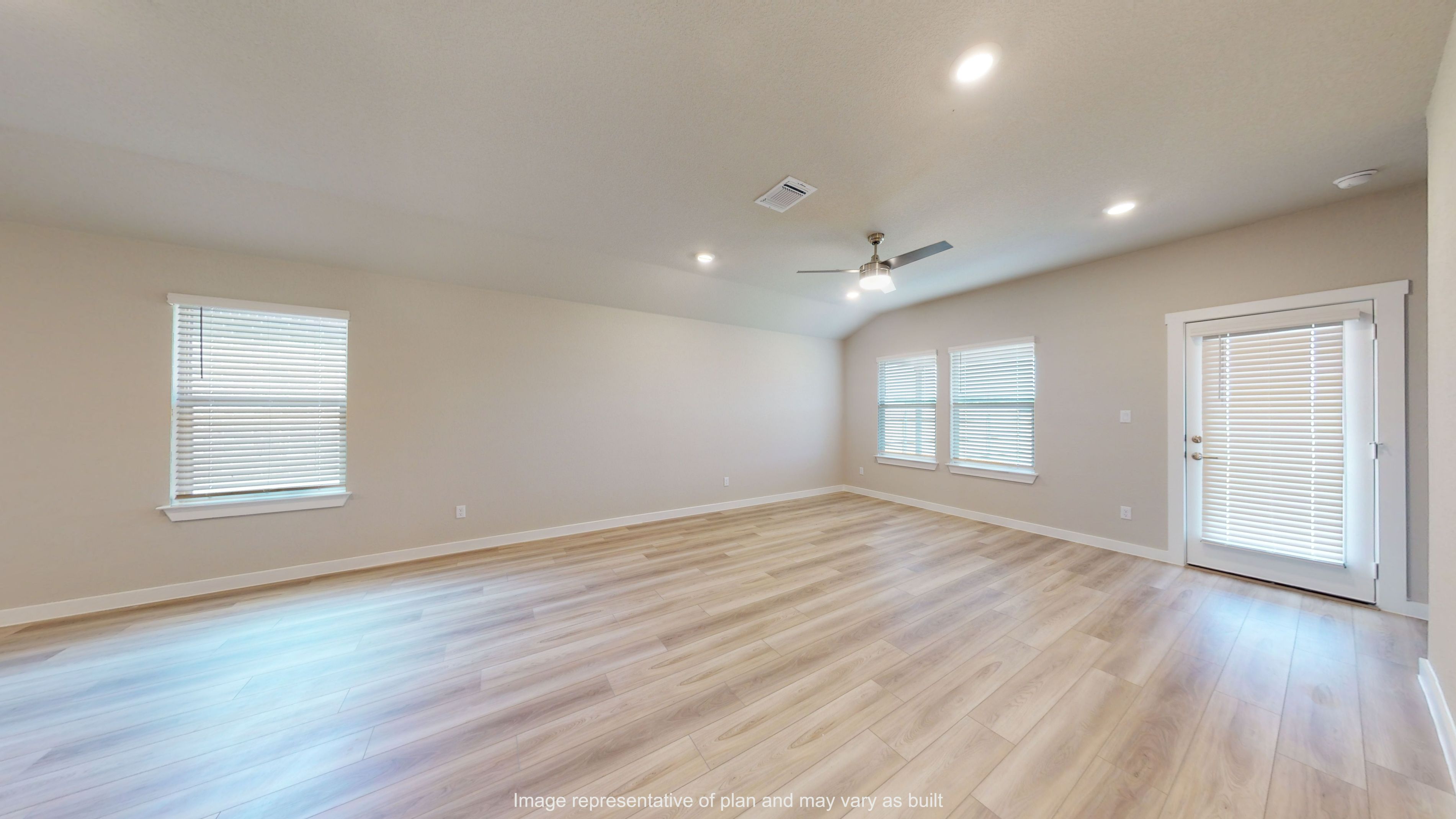 Gaven living room with vinyl plank flooring and large windows to backyard.