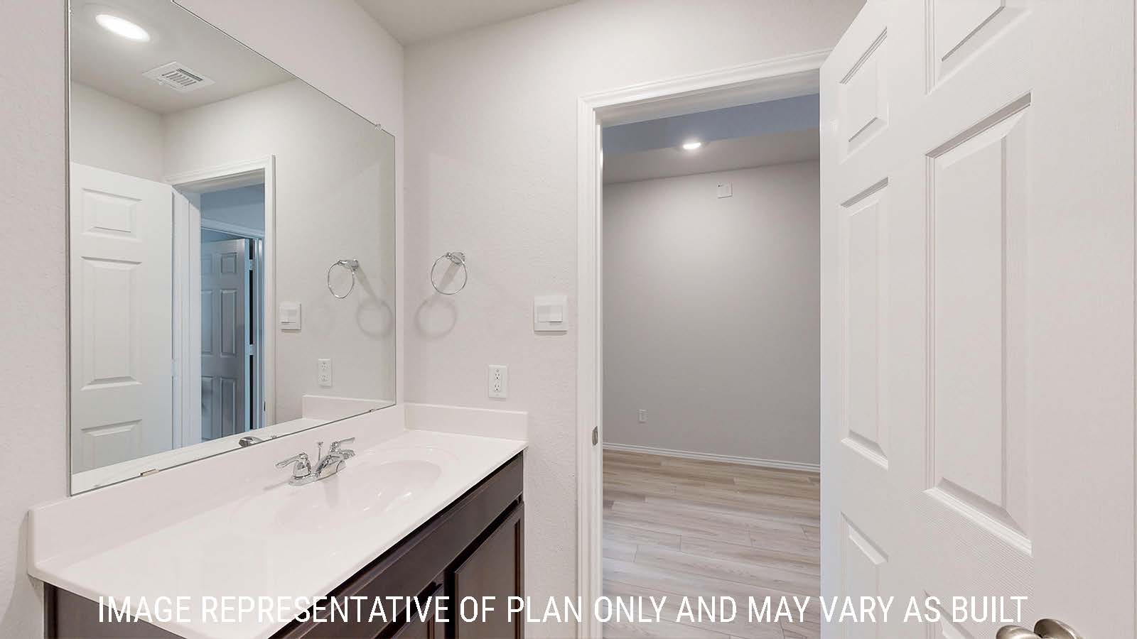 Harris secondary bathroom with vanity sink and view of front hallway.