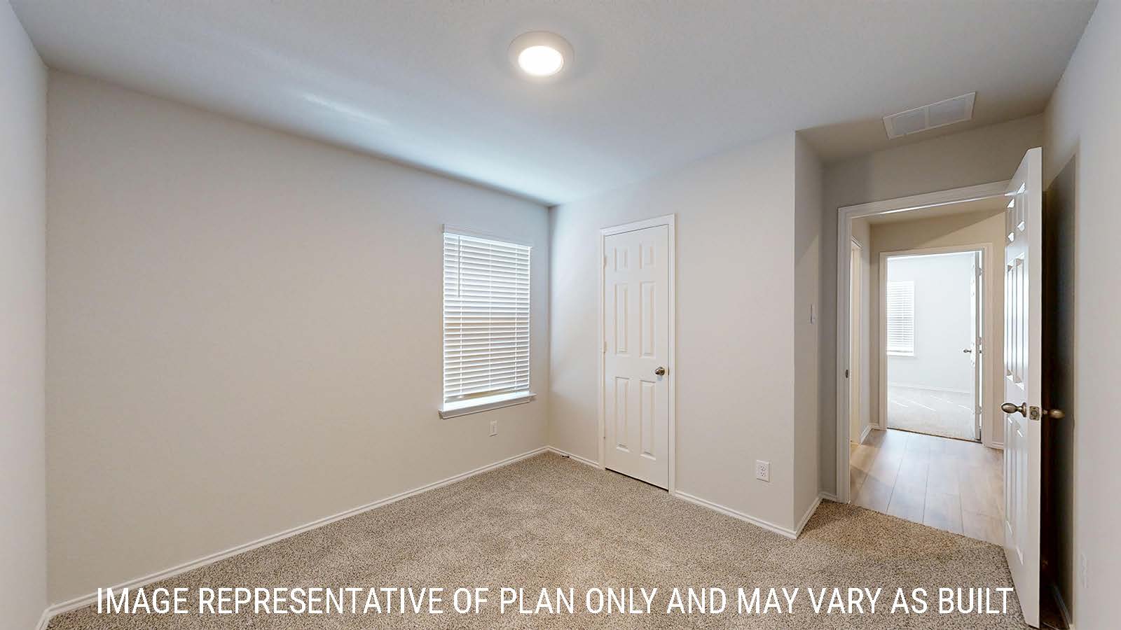 Harris secondary bedroom with carpeted flooring and view of hallway.