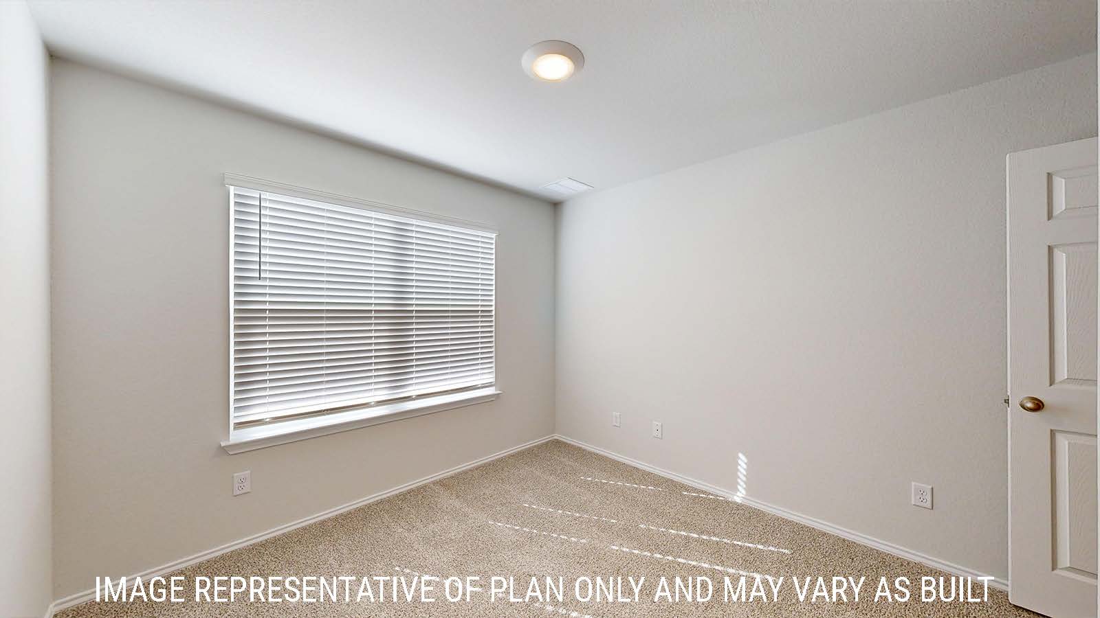 Harris secondary bedroom with carpeted flooring and window for lighting.