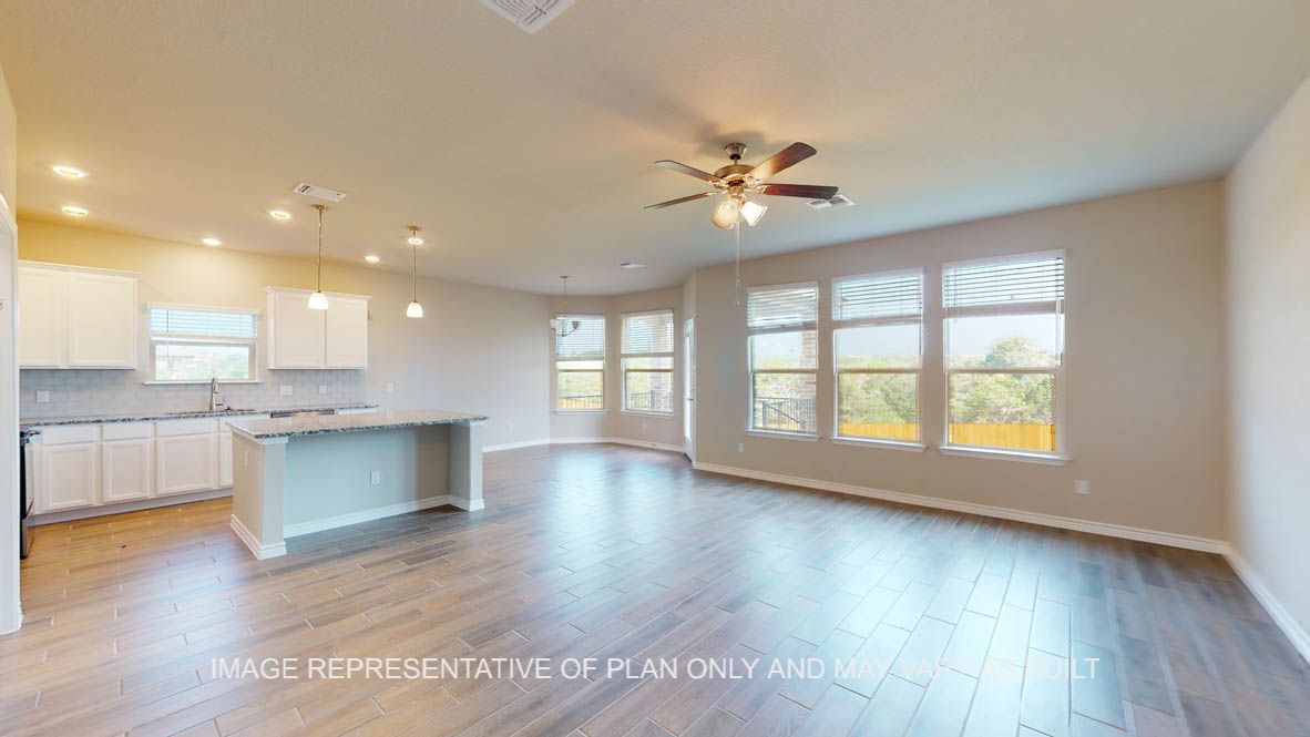 Kiawa living room open to the kitchen and breakfast area with vinyl plank flooring throughout.