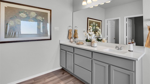 Turnbo Ranch Traditions primary bathroom double sink vanity and mirror.