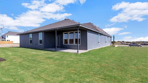 Turnbo Ranch Traditions model home backyard with view of the backdoor.