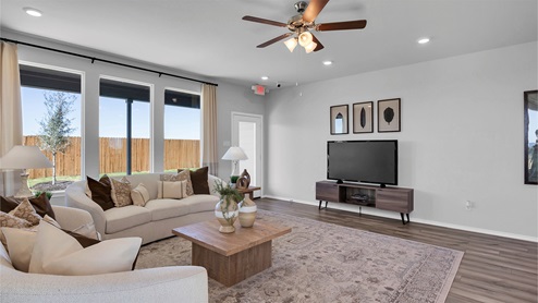 Turnbo Ranch Traditions model living room with view of the backyard and back door.