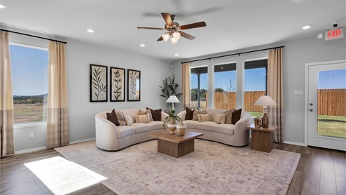 Turnbo Ranch Traditions model living room with view of the backyard and back door.