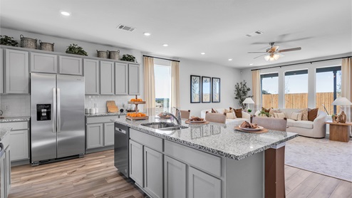 Turnbo Ranch Traditions model home kitchen island and view of the living room.