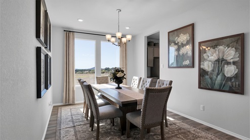 Turnbo Ranch Traditions model home dining room with view of the outside.