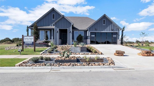 Turnbo Ranch Traditions model home exterior elevation with glass store front windows.