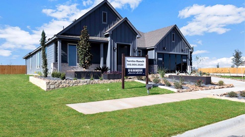 Turnbo Ranch Traditions model home exterior elevation with glass store front windows.