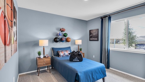 Oak Ridge model home secondary bedroom with twin bed and accent decor.