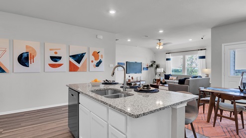 Oak Ridge model home kitchen with white cabinets and granite countertops.