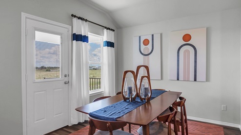 Oak Ridge model home dining room with dining room table and decorative accents.