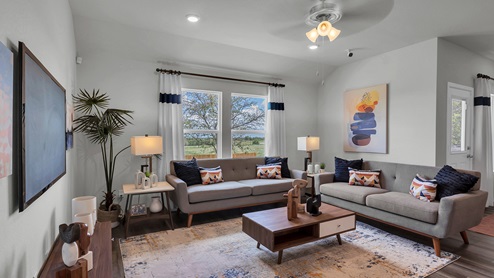 Oak Ridge model home living room with furniture and windows offering natural lighting.