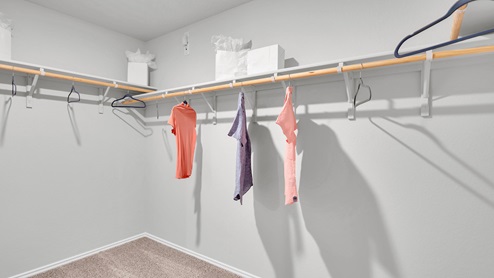 Oak Ridge model home primary bedroom walk-in closet.