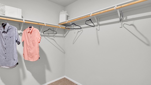 Oak Ridge model home primary bedroom walk-in closet.