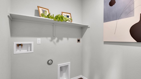 Oak Ridge model home utility room with washer and dryer connections.