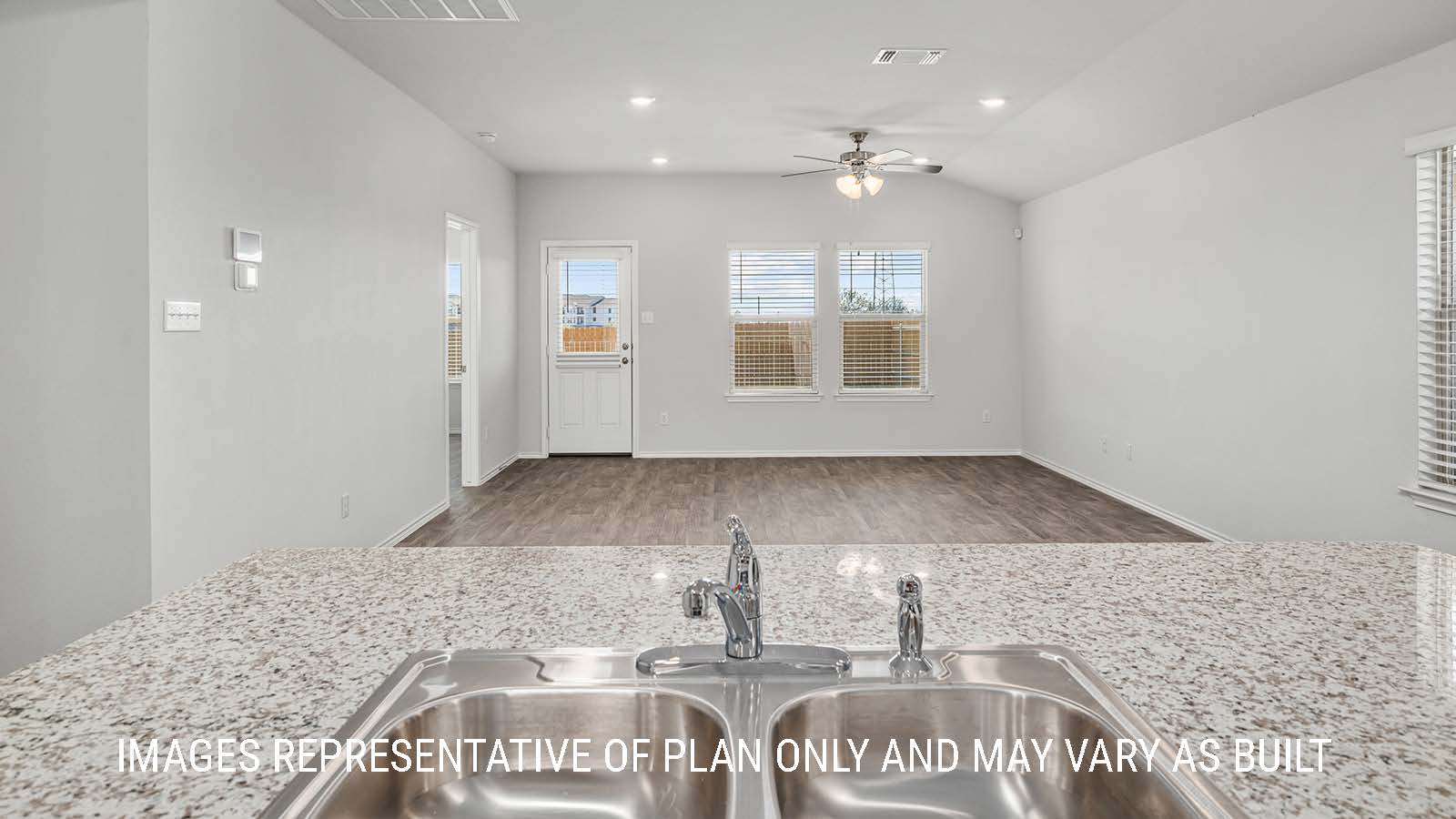 Elgin kitchen center island with garntie countertops and view of living room.