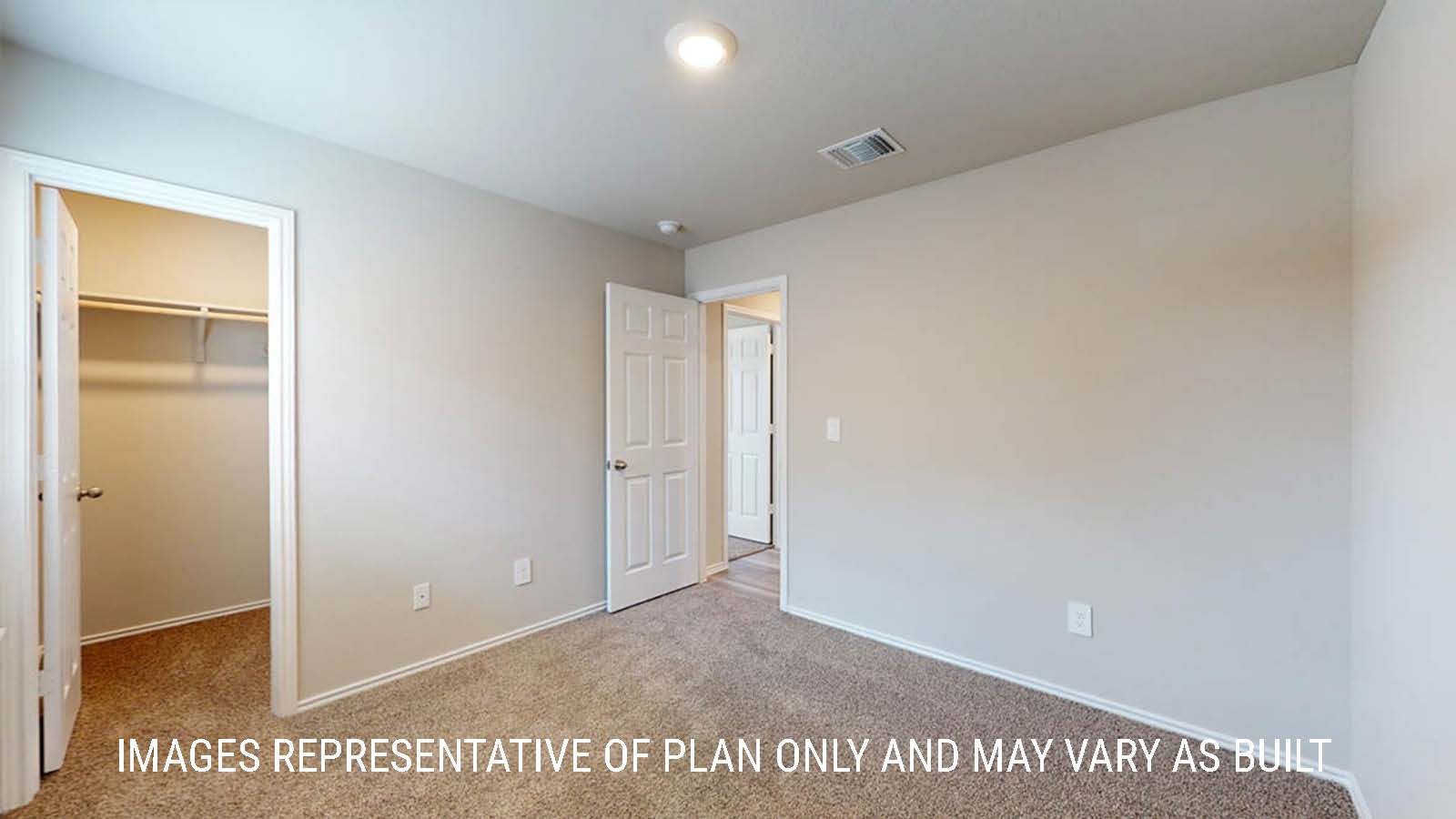 Fargo secondary bedroom with closet and carpeted flooring.