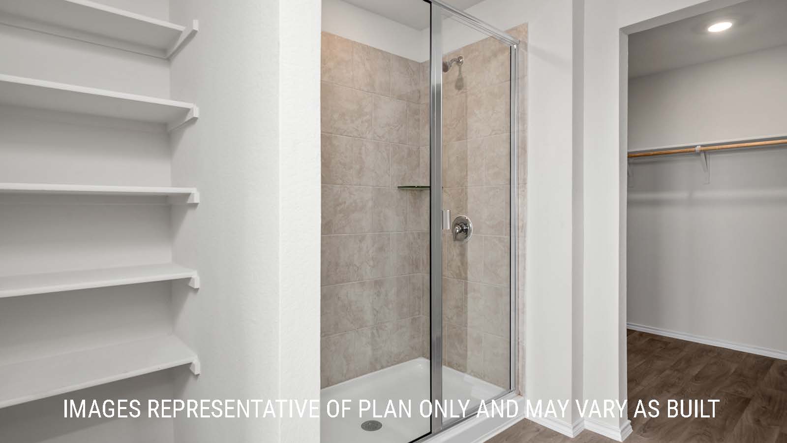 Fargo primary bathroom with walk-in shower and view of primary closet.