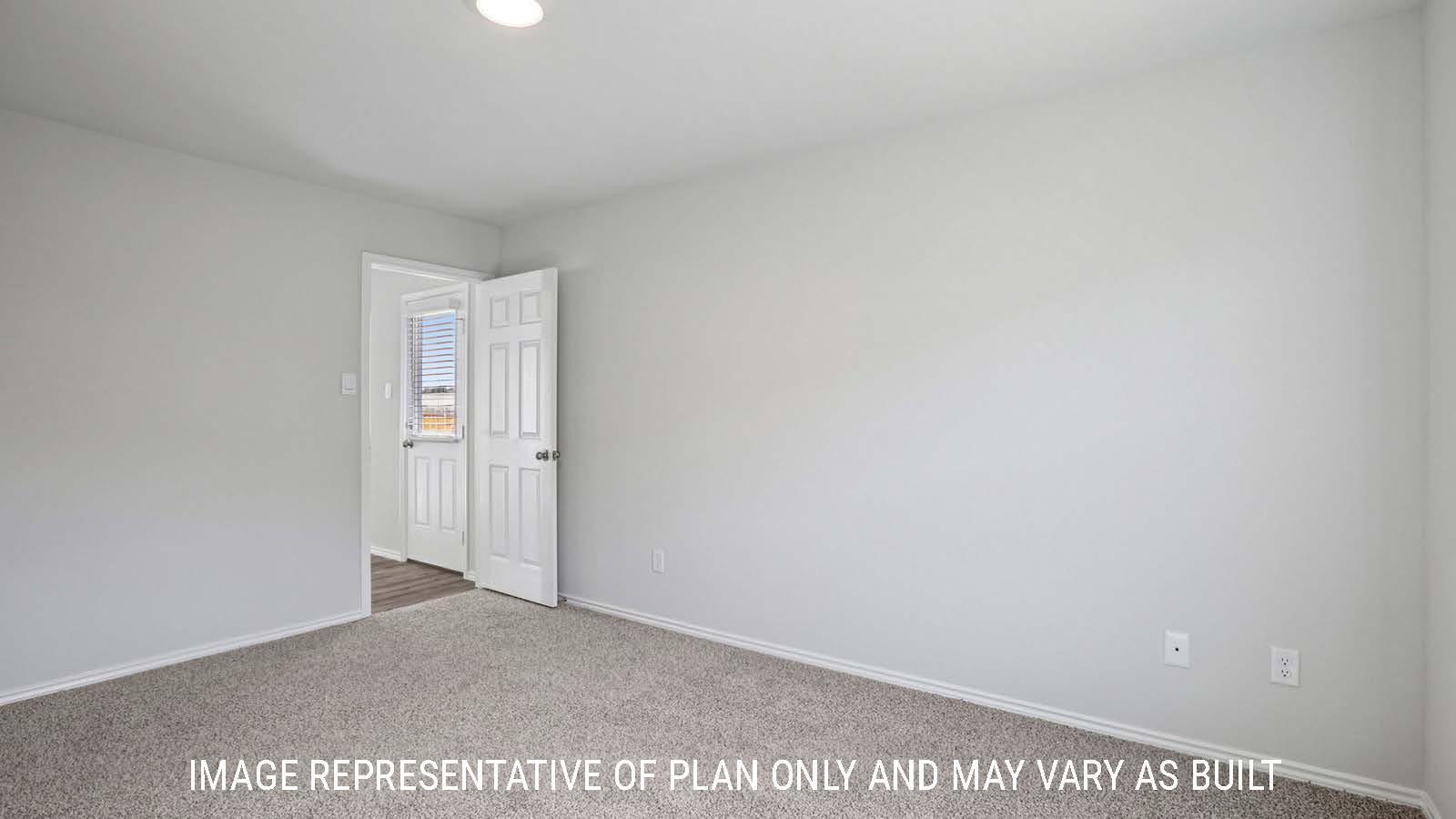 Atlanta primary bedroom with carpeted flooring and view of open concept living room.