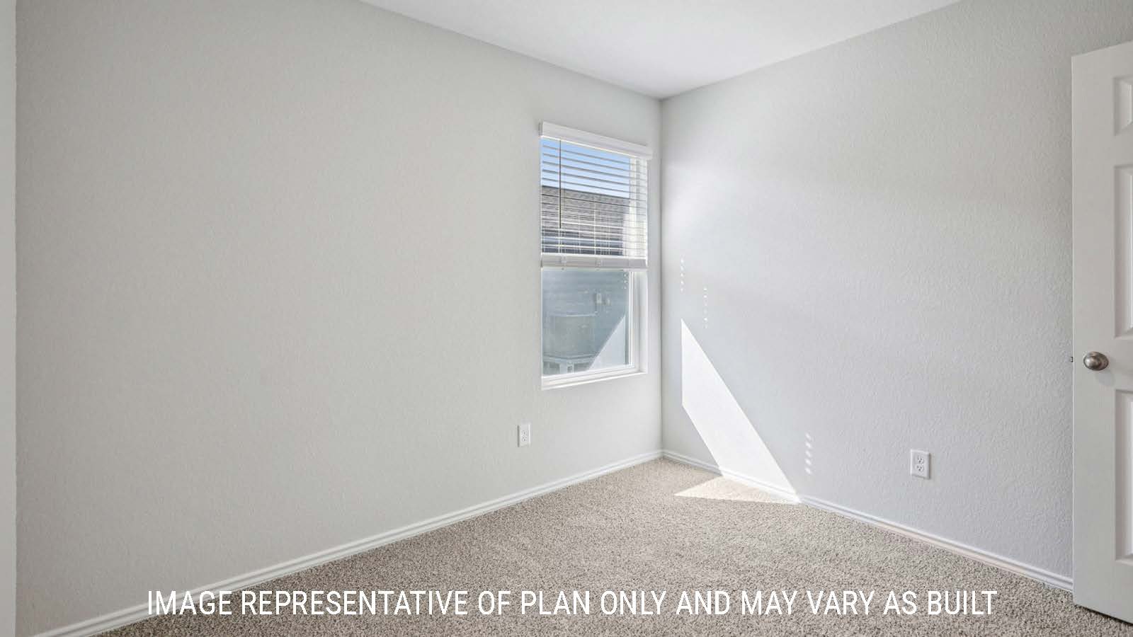 Atlanta secondary bedroom with carpeted flooring and window for lighting.