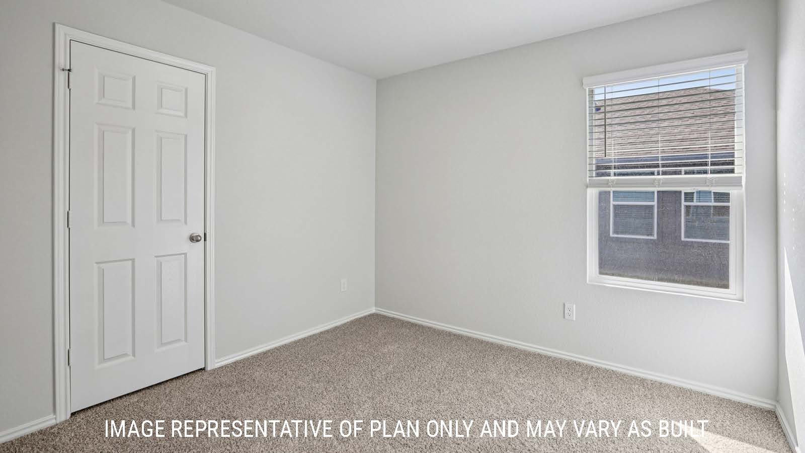 Atlanta secondary bedroom with carpeted flooring and window for lighting.