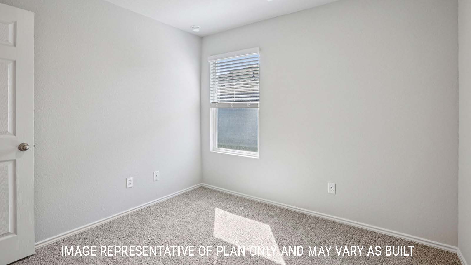 Atlanta secondary bedroom with carpeted flooring and window for lighting.