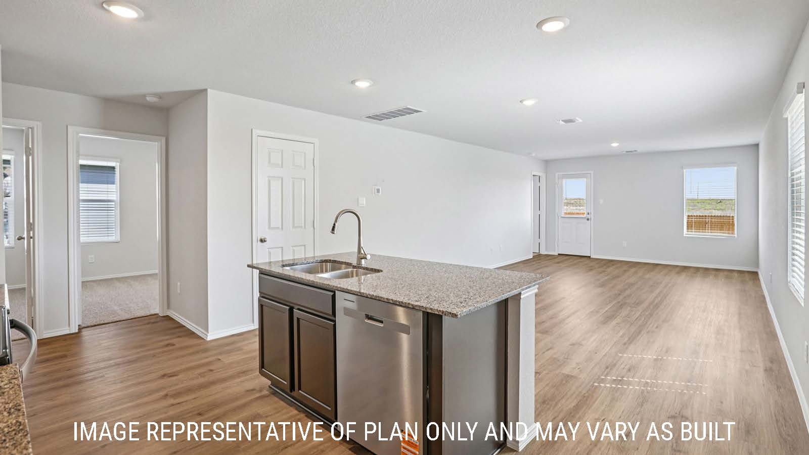 Barton kitchen with kitchen island and view of open concept dining room and living room.