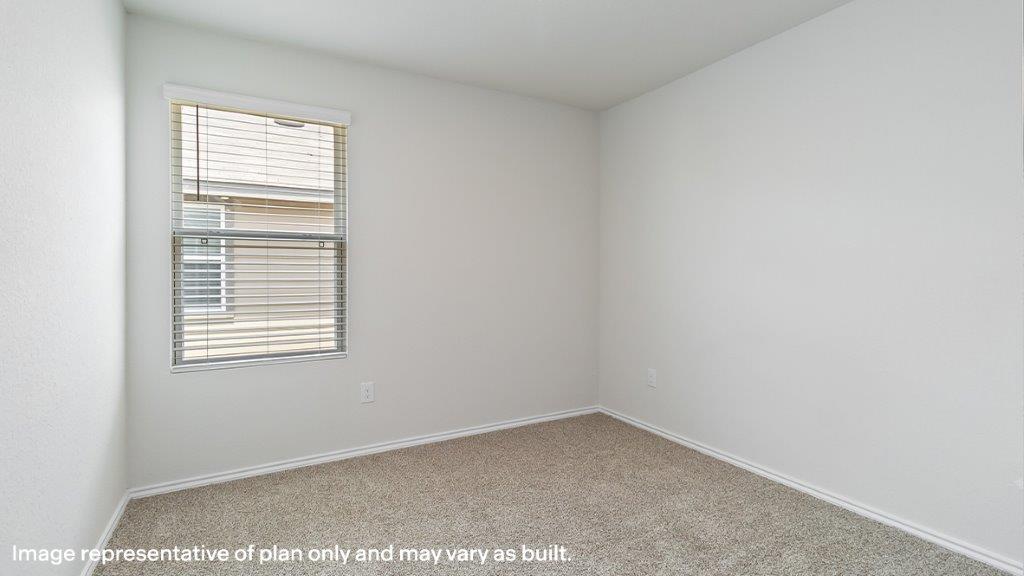 Barton secondary bedroom with carpeted flooring and window.