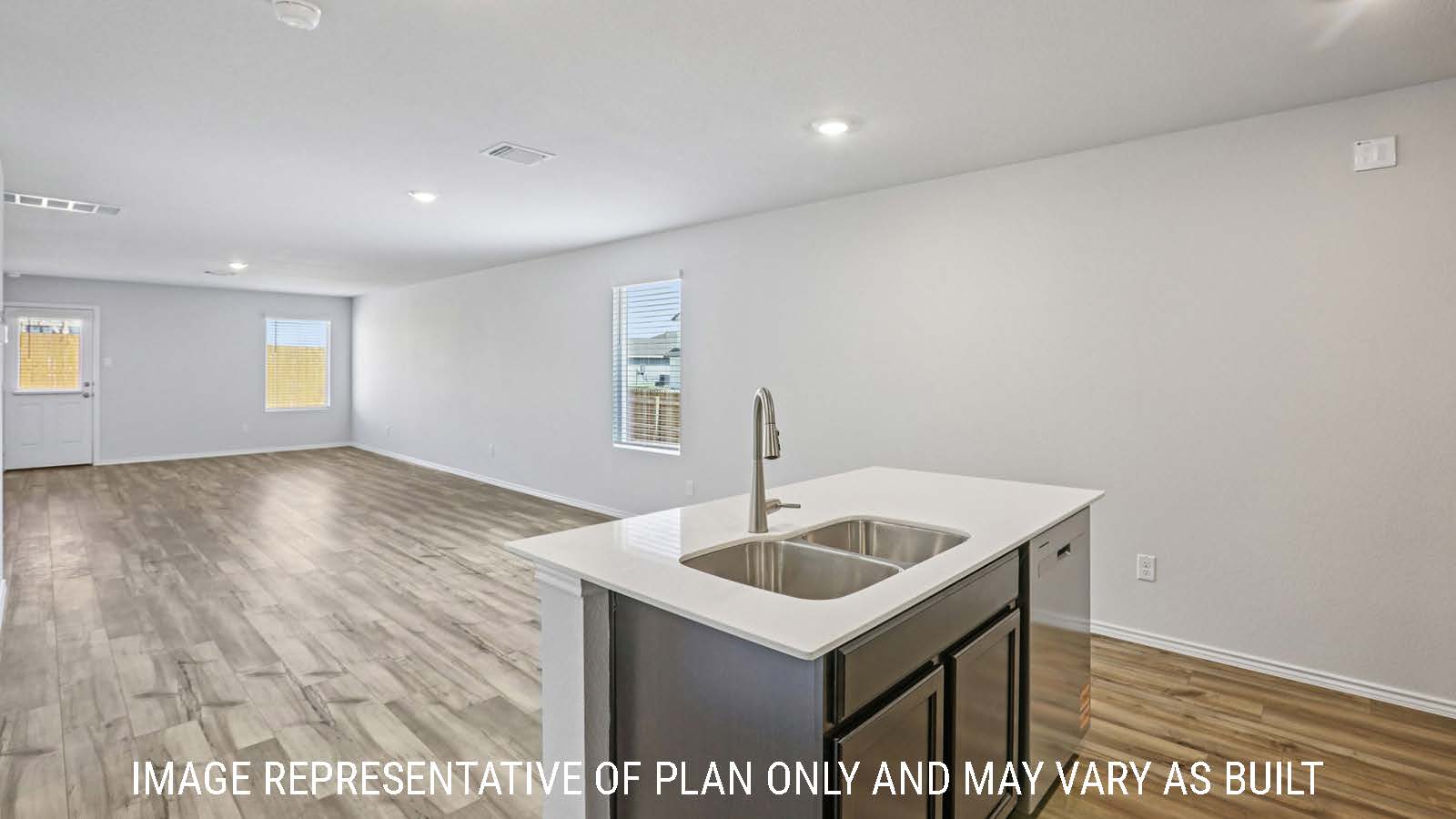 Caprock kitchen with kitchen island and view of open concept dining room and living room.