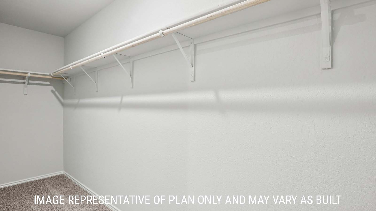 Estero secondary bedroom with carpeted flooring and view of hallway.