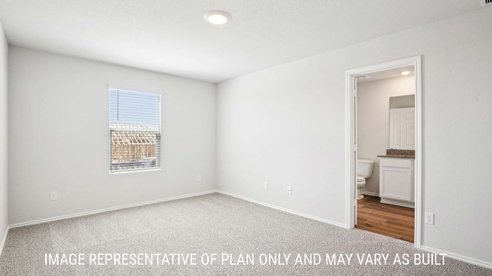 Franklin primary bedroom with carpeted flooring and view of primary bathroom.