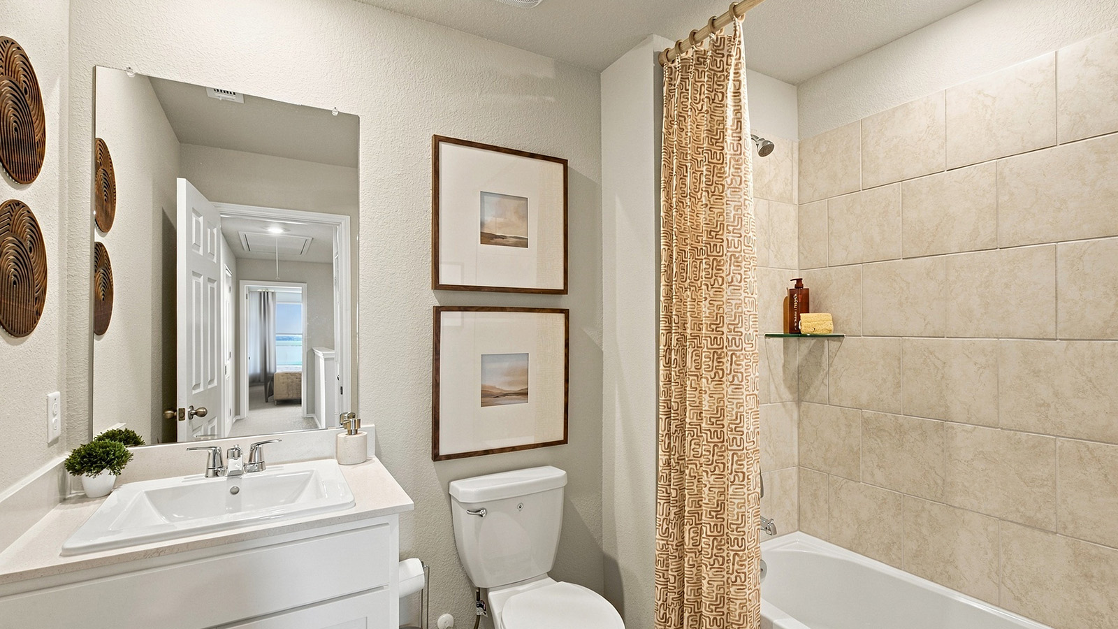Pepper Creek Crossing model secondary bathroom with vanity sink and shower and tub combo.