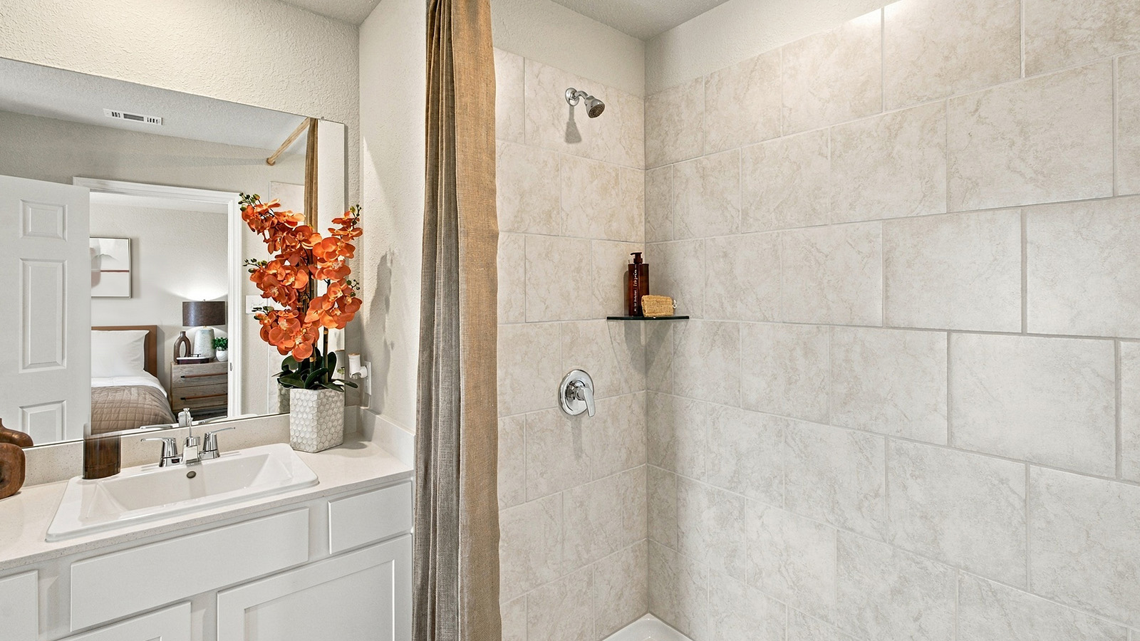 Pepper Creek Crossing model primary bathroom with vanity sink and walk-in shower.
