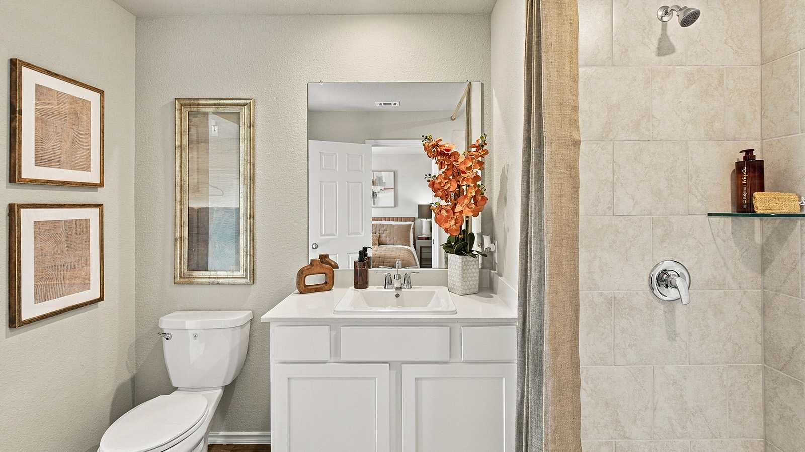 Pepper Creek Crossing model primary bathroom with vanity sink and walk-in shower.