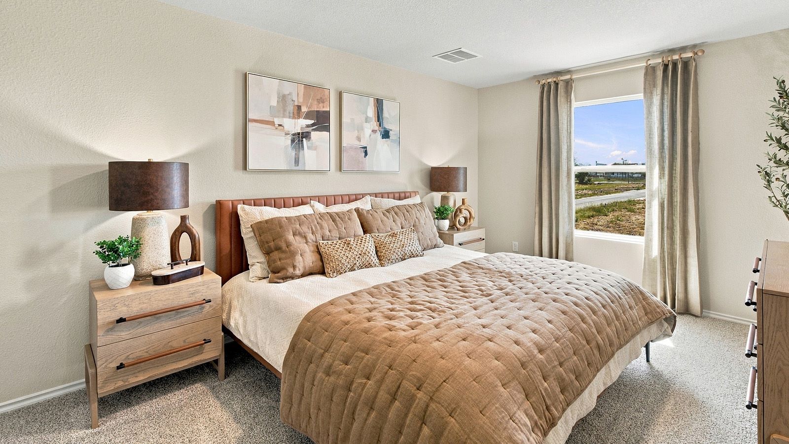 Pepper Creek Crossing model primary bedroom with carpeted flooring and window for natural lighting.