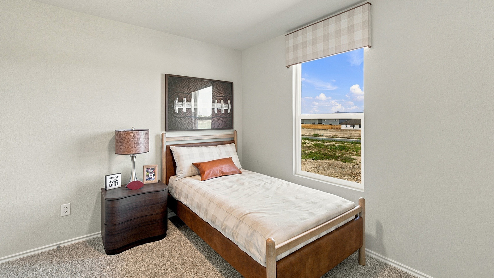 Pepper Creek Crossing model secondary bedroom with carpeted flooring and window for natural lighting.