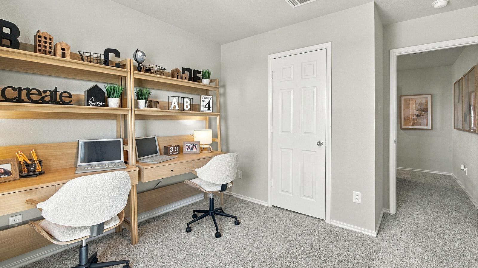Pepper Creek Crossing model secondary bedroom with carpeted flooring and view of hallway.