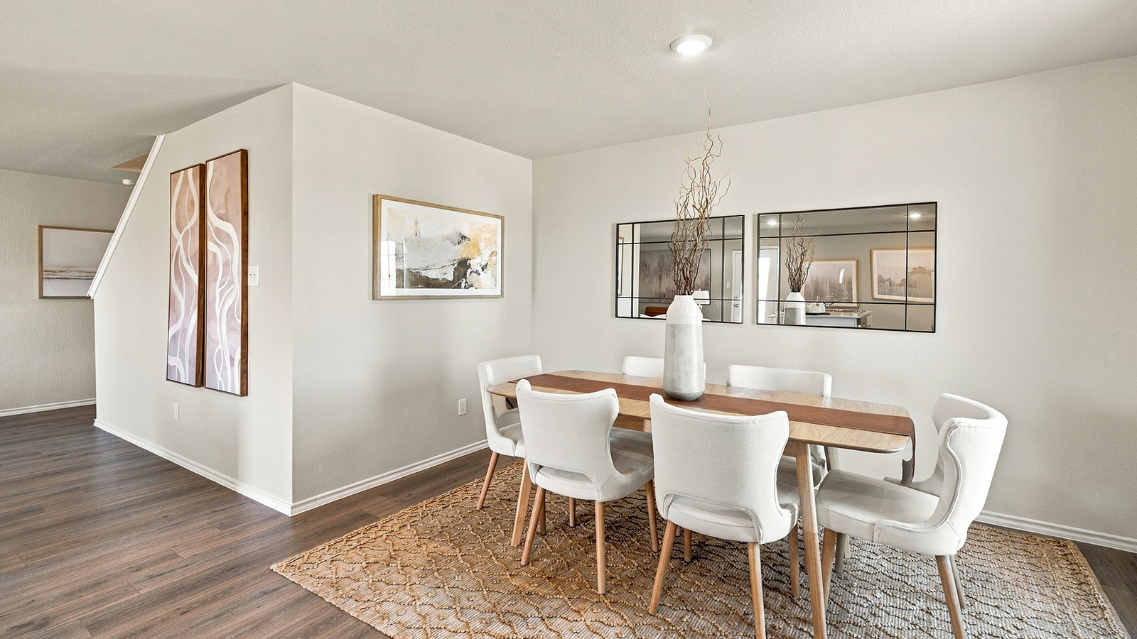 Pepper Creek Crossing model dining room with vinyl flooring and window for natural lighting.