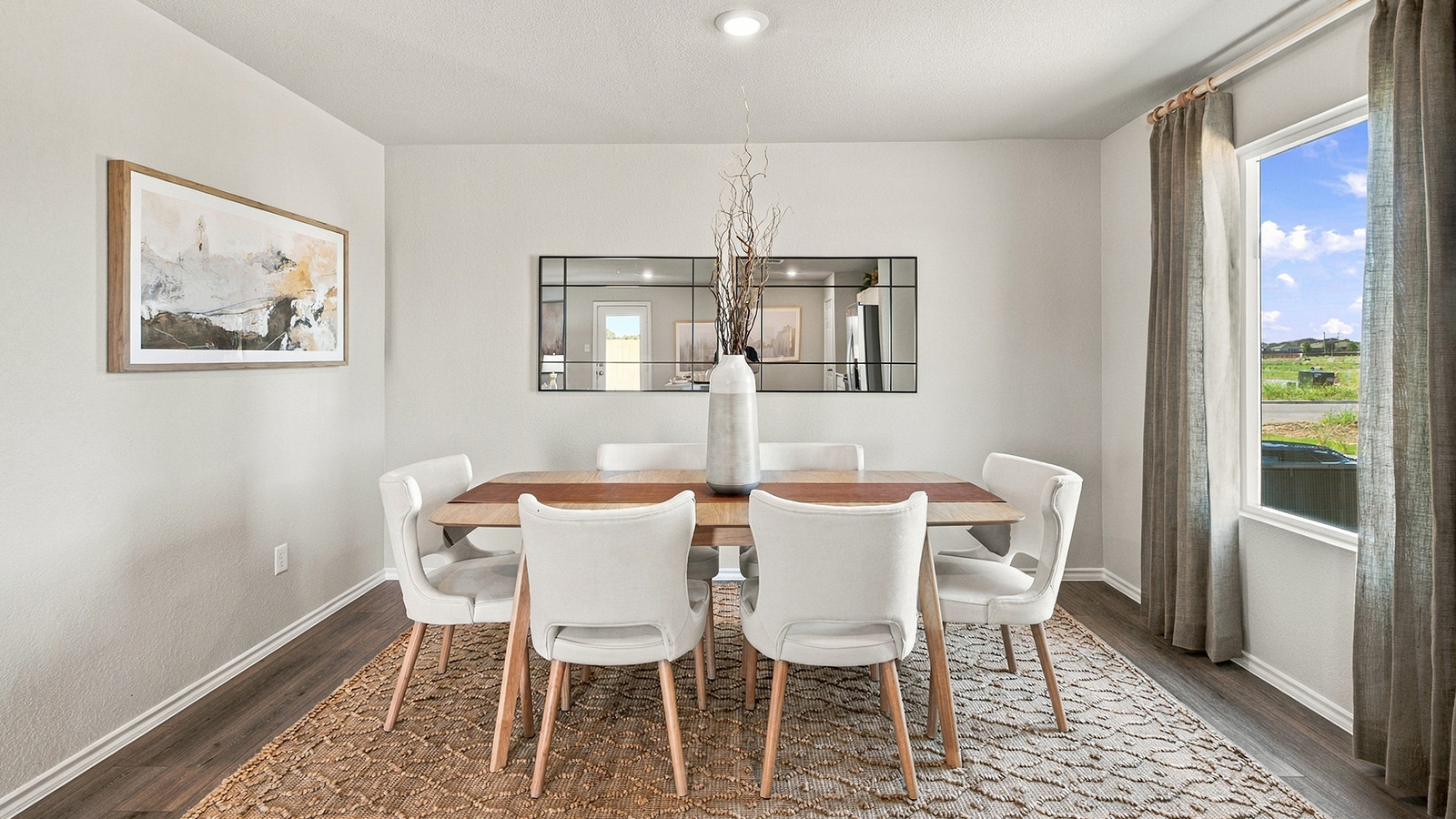 Pepper Creek Crossing model dining room with vinyl flooring and window for natural lighting.