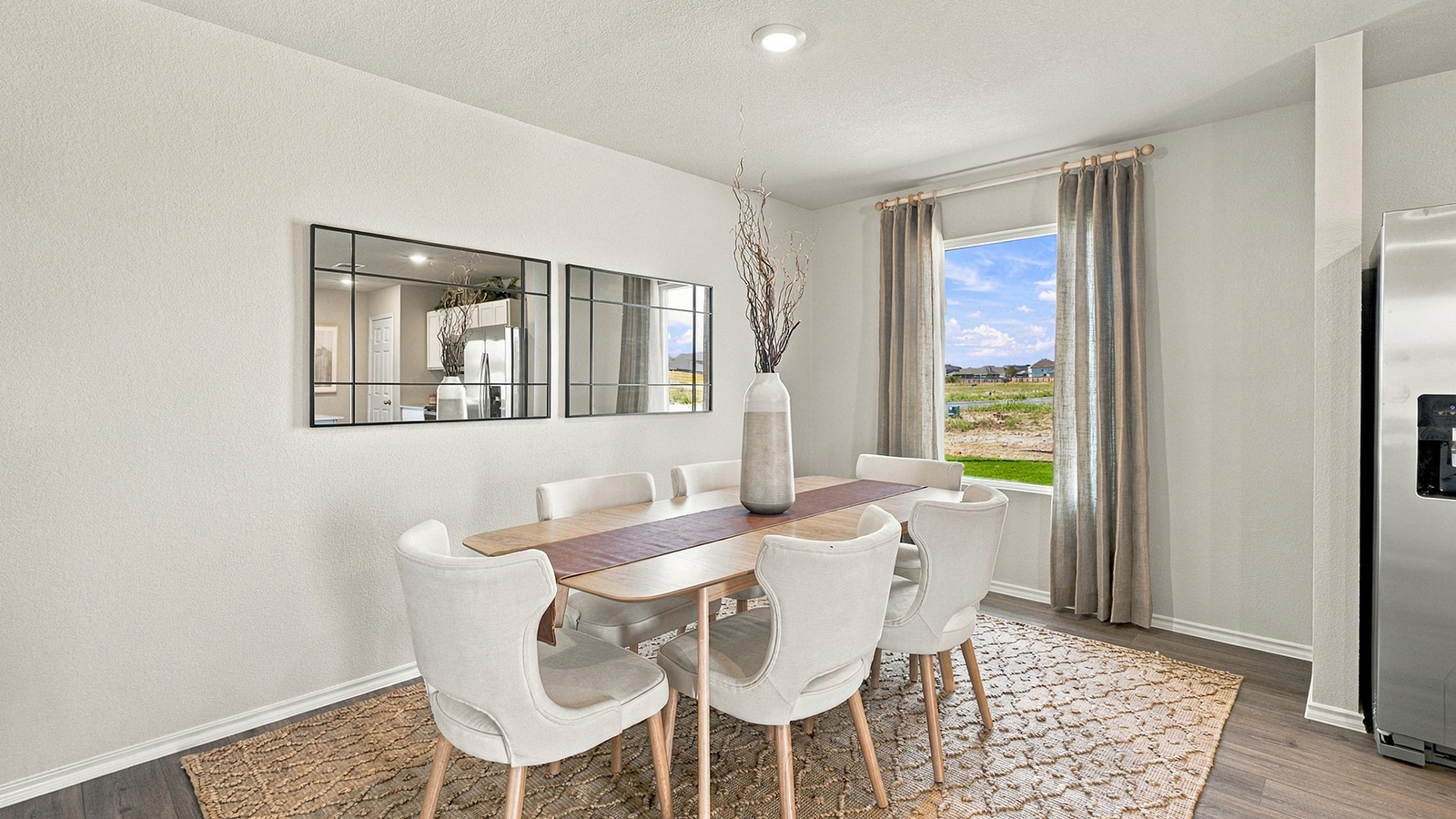Pepper Creek Crossing model dining room with vinyl flooring and window for natural lighting.