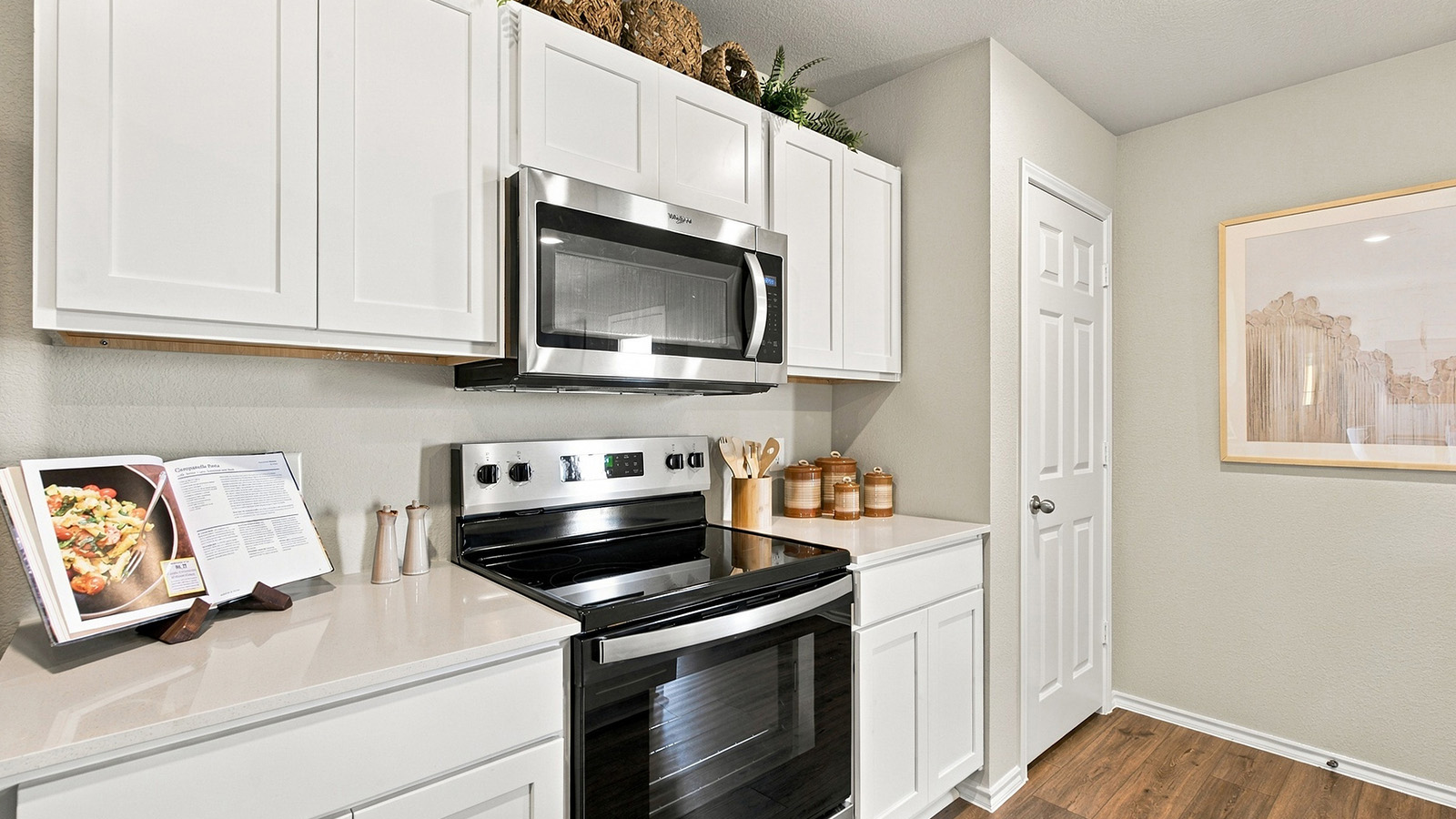 Pepper Creek Crossing model kitchen with light cabinets and granite countertops.