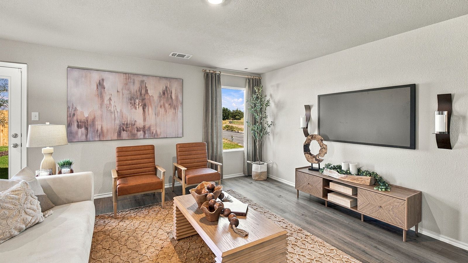 Pepper Creek Crossing model living room with vinyl flooring and window for natural lighting.