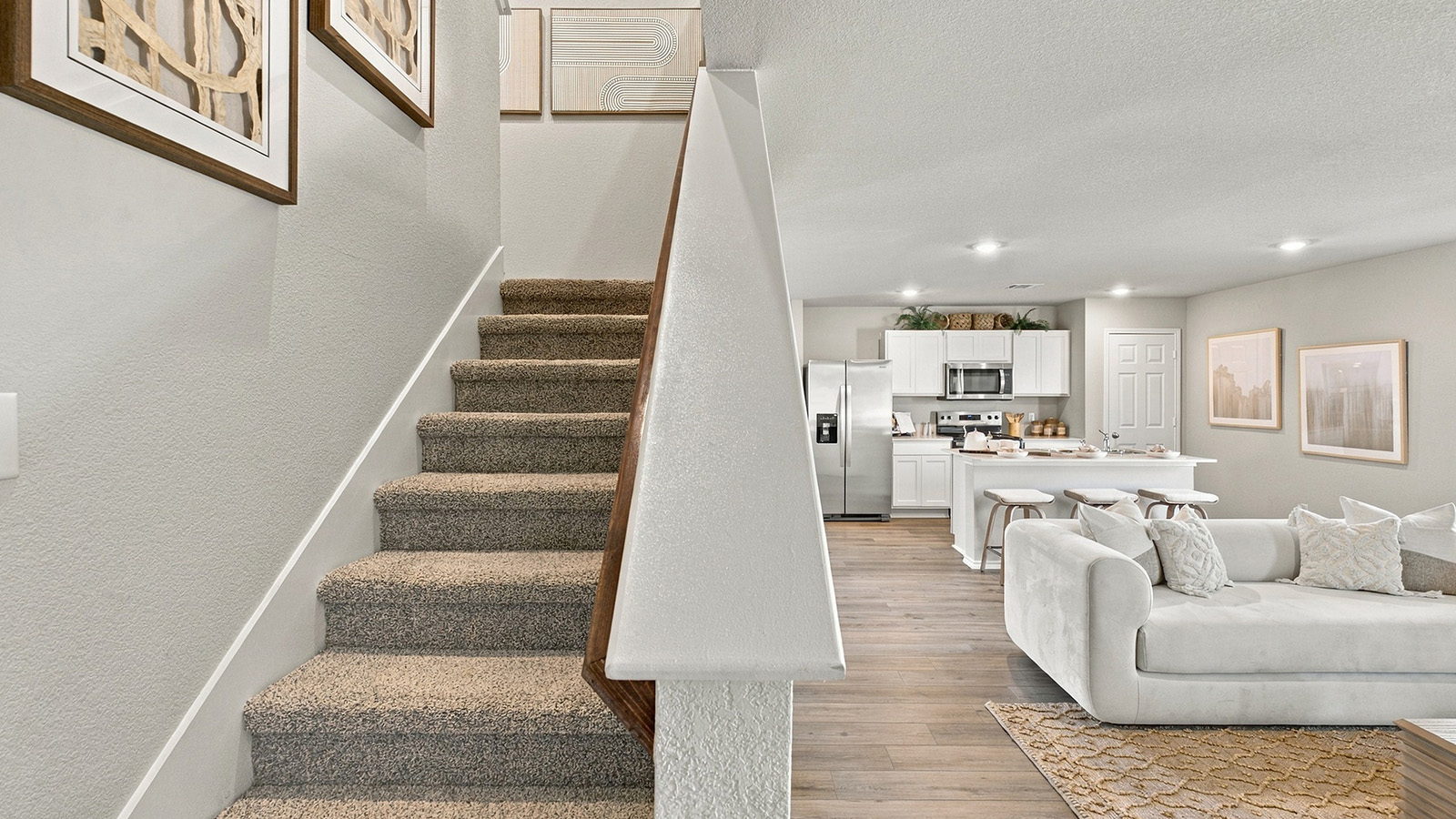 Pepper Creek Crossing model entry with view of stairs and open concept living room.