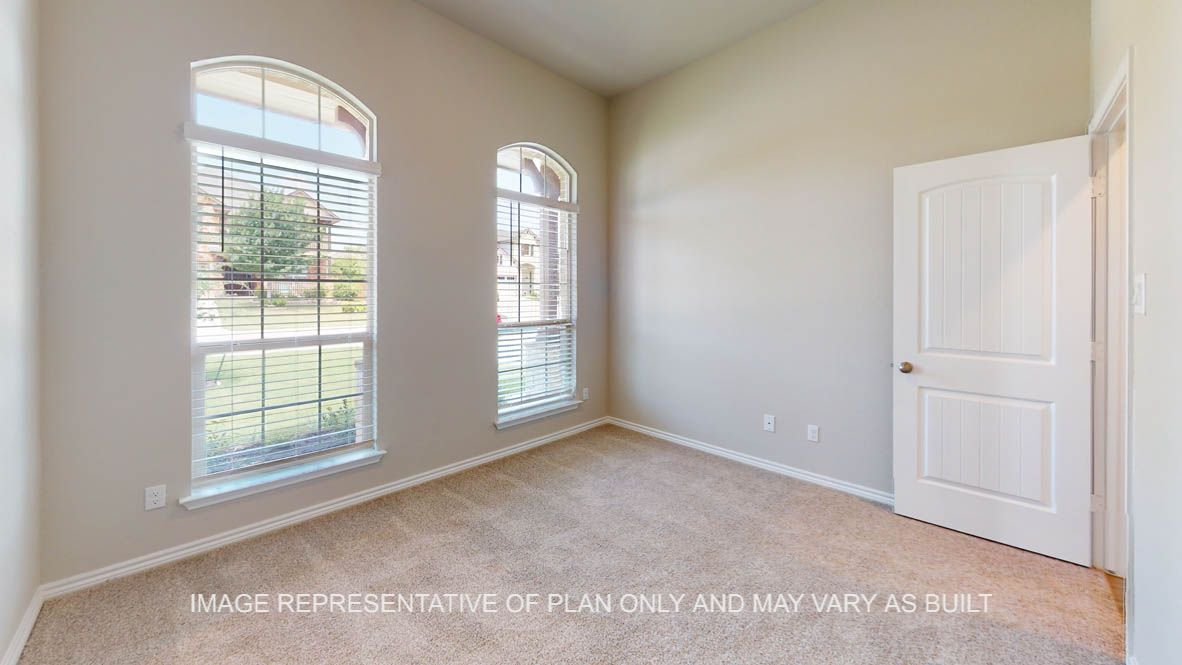 Sierra secondary bedroom with carpet flooring and windows with view to the front of the house.