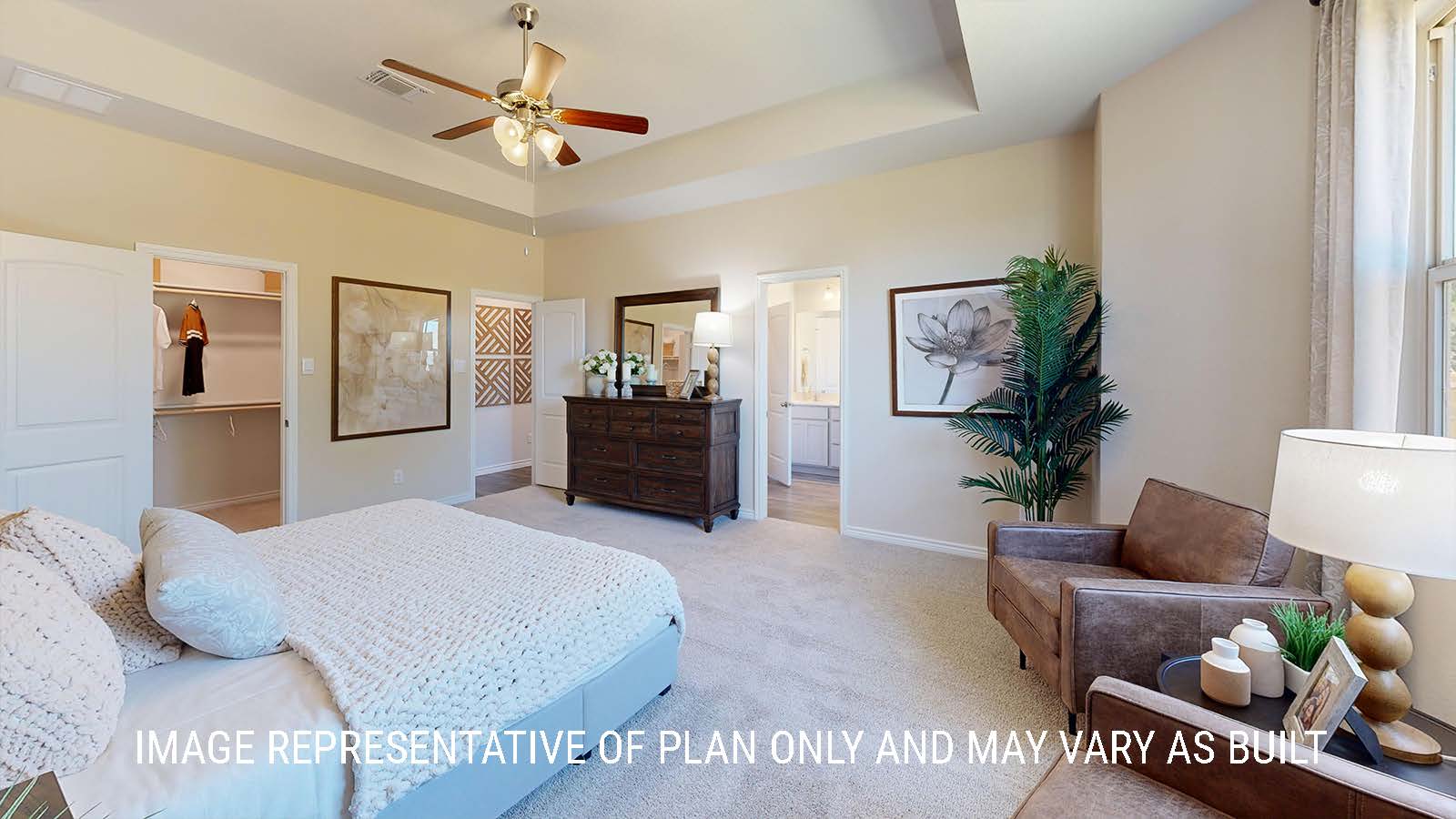 Newburgh primary bedroom with carpeted flooring and view of primary bathroom.