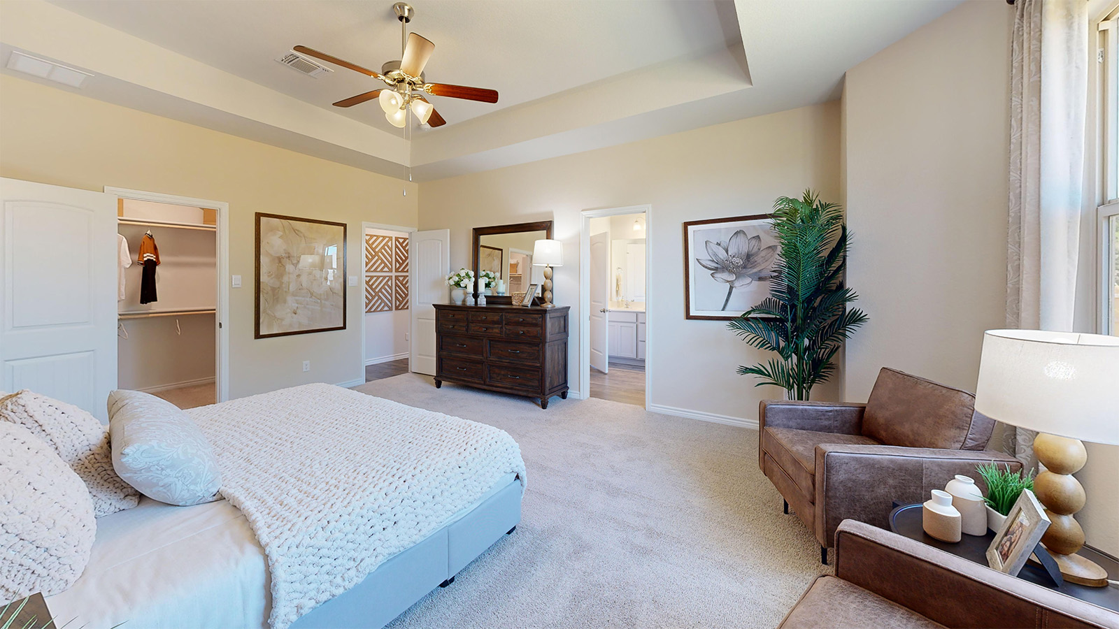 Newburgh primary bedroom with carpeted flooring and view of primary bathroom.