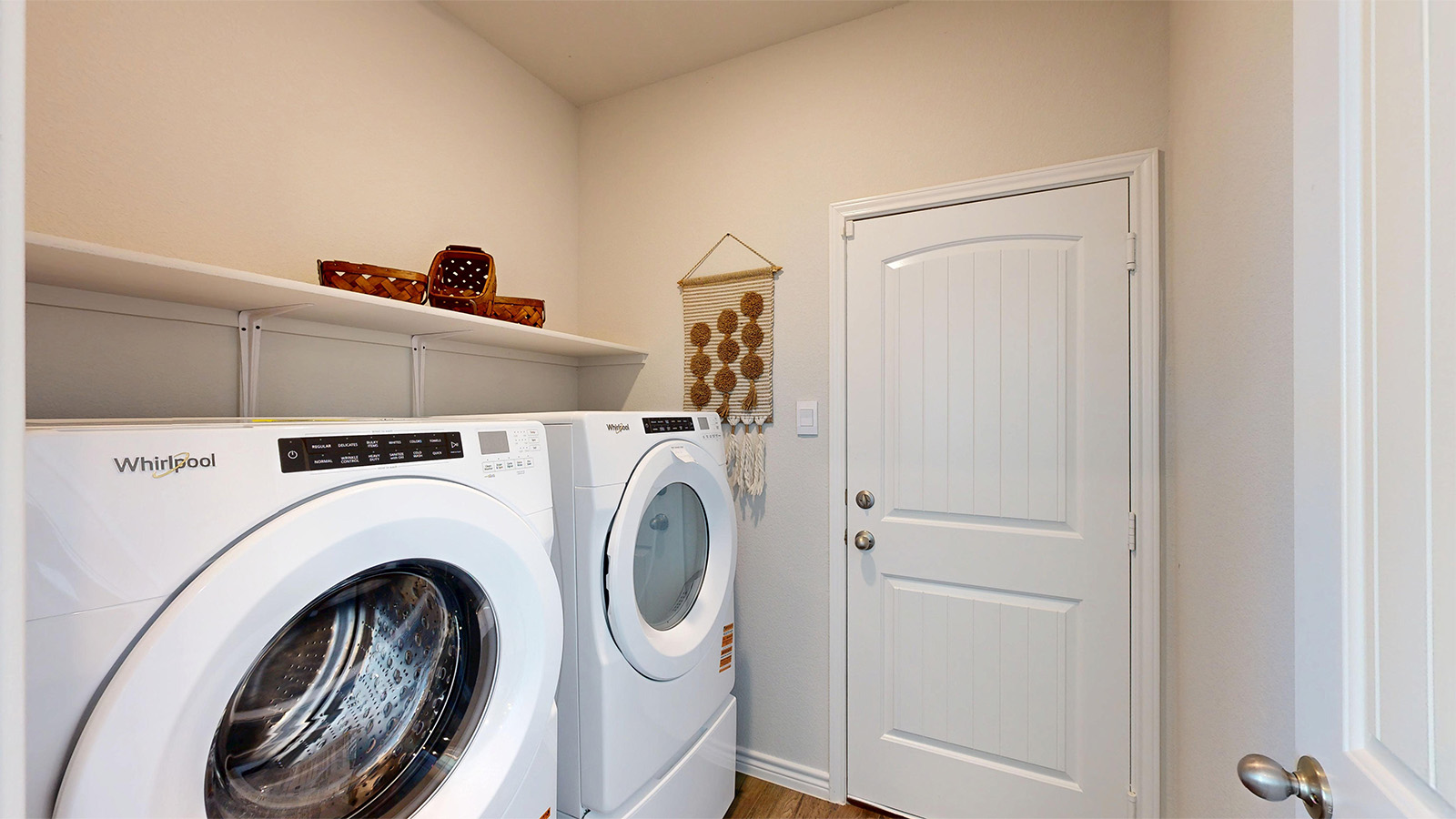 Newburgh utility with washer and dryer and shelving for storage.