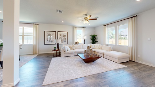 Newburgh living room with windows for lighting and view of back yard.