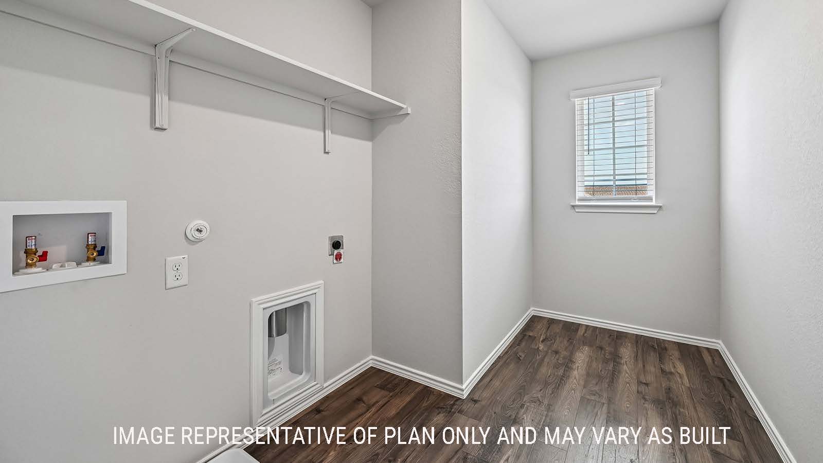 Madison utility room with washer and dryer connections and shelving for storage.